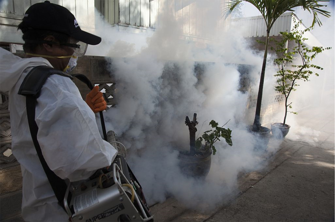 A mosquito repellant fogging operation being carried out by Public Health dengue prevention staff outside Bangkok, June 2012
