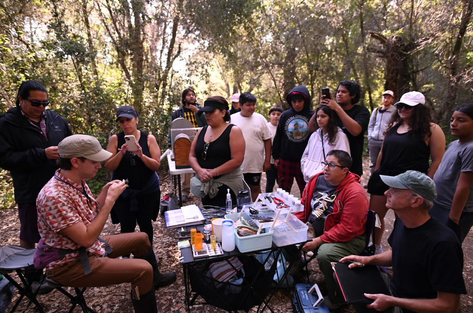 Tribal members seeing bird banding by Julian Tattoni and Katie LaBarbera. Photo by Marina Luccioni.