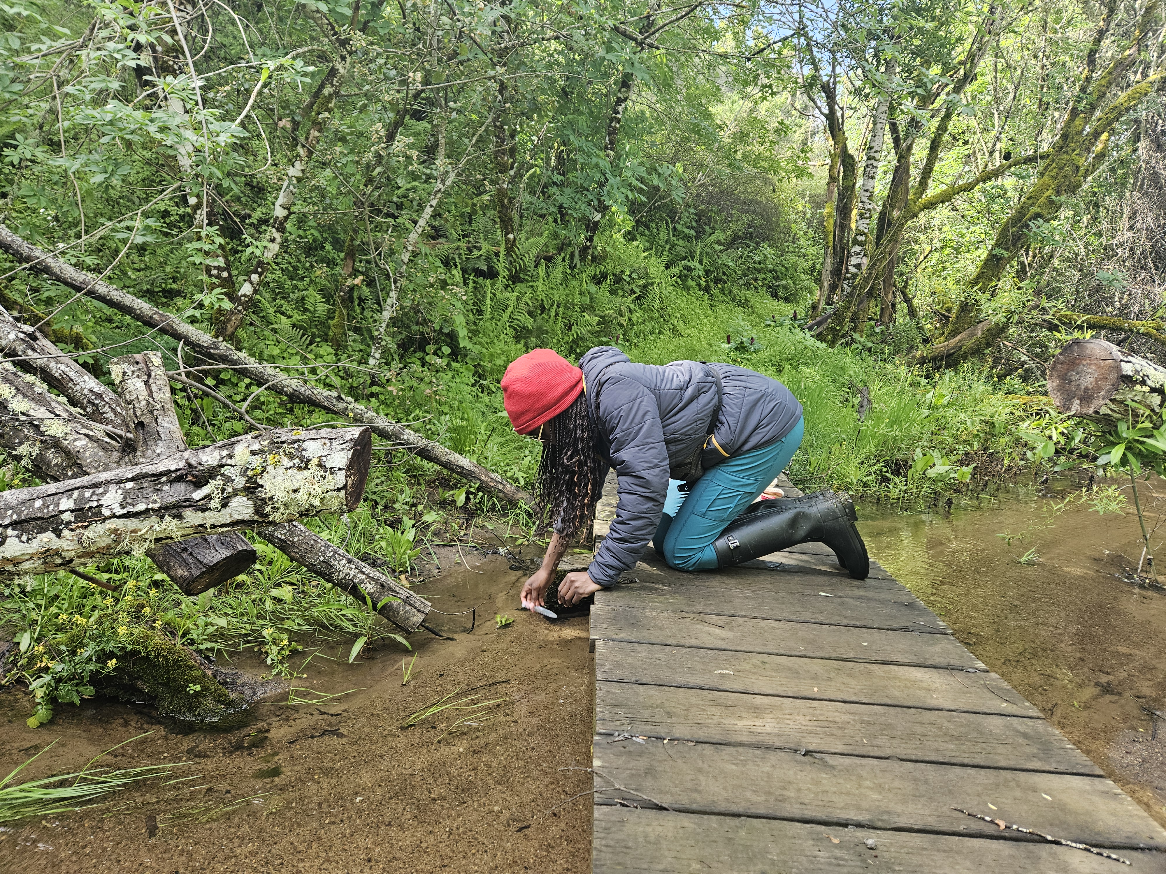 Teso Coker collects water from the river along trail 12