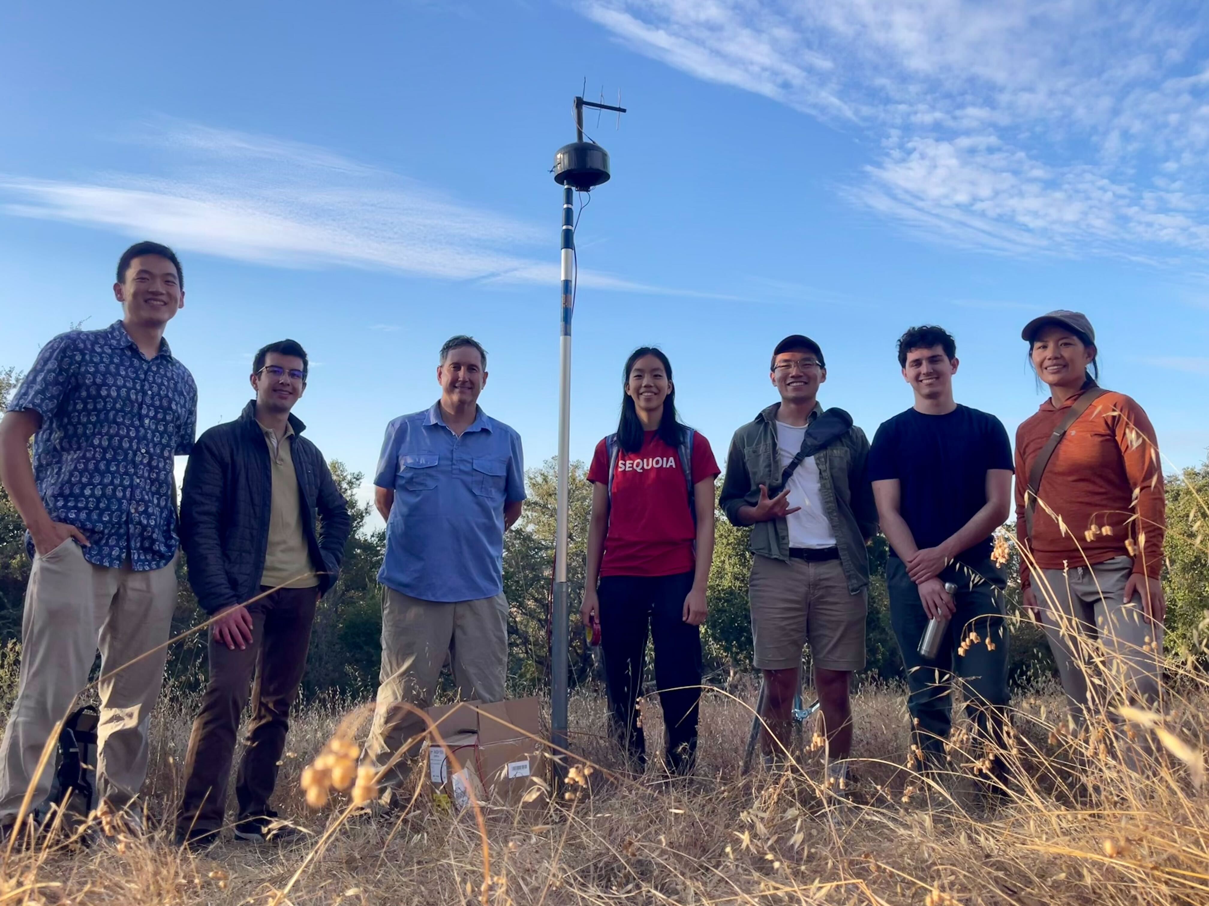 Members of the Stanford Smoke Mesh (SMesh) network stand around their installed sensor