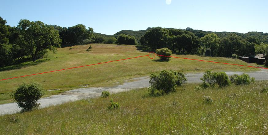 View of the experiment with Searsville parking area in foreground. The red circle marks the electrodes at vertex, and red lines indicate buried wires to other electrodes.