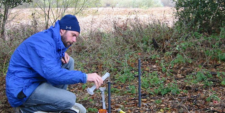 After measuring soil water potential, Chris removes the seal on the tensiometer and replaces water that has infiltrated.