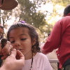 Muweuka youth member Aria Cazares looking at a Swainson’s thrush as PhD student Julian Tattoni shows how to band a bird. Photo by Marina Luccioni.