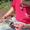 Adrian Wackett removes soil from a slide hammer